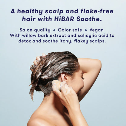 Woman washing hair with shampoo bar. HiBAR Soothe shampoo bar gives you a healthy scalp and flake-free hair, is salon-quality, color-safe, vegan, and contains willow bark extract and salicylic acid to detoxify and soothe itchy, flakey scalps.