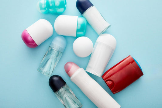 Various deodorant types on a light blue background.