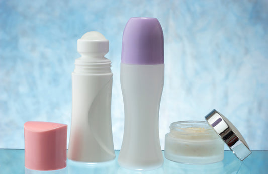 Three deodorants on a blue and white background.