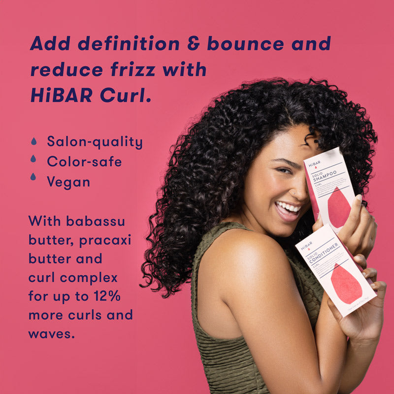 Woman holding HiBAR Curl Shampoo Bar and Conditioner Bar packaging. HiBAR Curl Shampoo Bar and Conditioner bars add definition & bounce and reduces frizz, is salon-quality, color-safe, vegan, and contains babassu butter, pracaxi butter and curl complex for up to 12% more curls and waves.