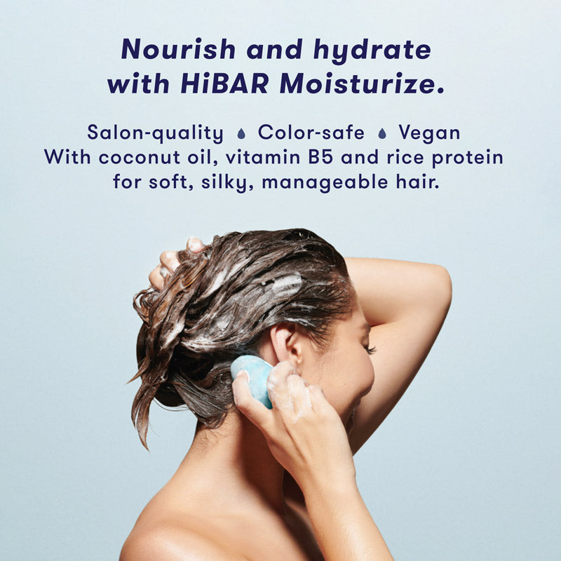 Woman washing hair with shampoo bar. HiBAR Moisturize shampoo bar and conditioner bar nourishes and hydrates, is salon-quality, color-safe, vegan, and contains coconut oil, vitamin B5 and rice protein for soft, silky, manageable hair.