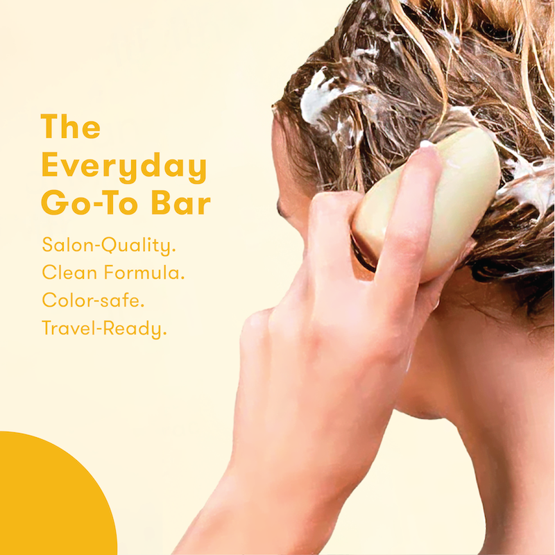 Person using shampoo bar to wash their hair with the words: The everyday go-to bar. Salon-quality. Clean formula. Color-safe. Travel-ready.