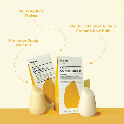 HIBAR solid shampoo bar and conditioner bars with packaging on a yellow background with product callouts: Helps reduce flakes. Promotes scalp comfort. Gently exfoliates to help promote new hair.