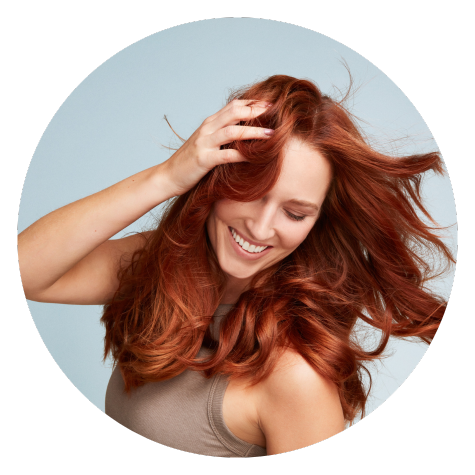 Red haired woman shaking her hair
