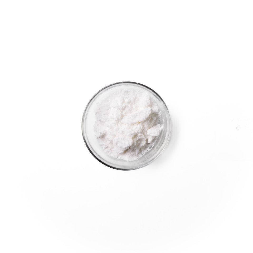 Vitamin_B5 in a glass dish. It is a white colored powder.