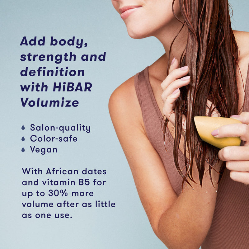 Woman washing hair with shampoo bar. HiBAR Volumize conditioner bar gives your hair body, strength and definition, and is salon-quality, color-safe, vegan, and contain African dates and vitamin B5 for up to 30% more volume after as little as one use. 