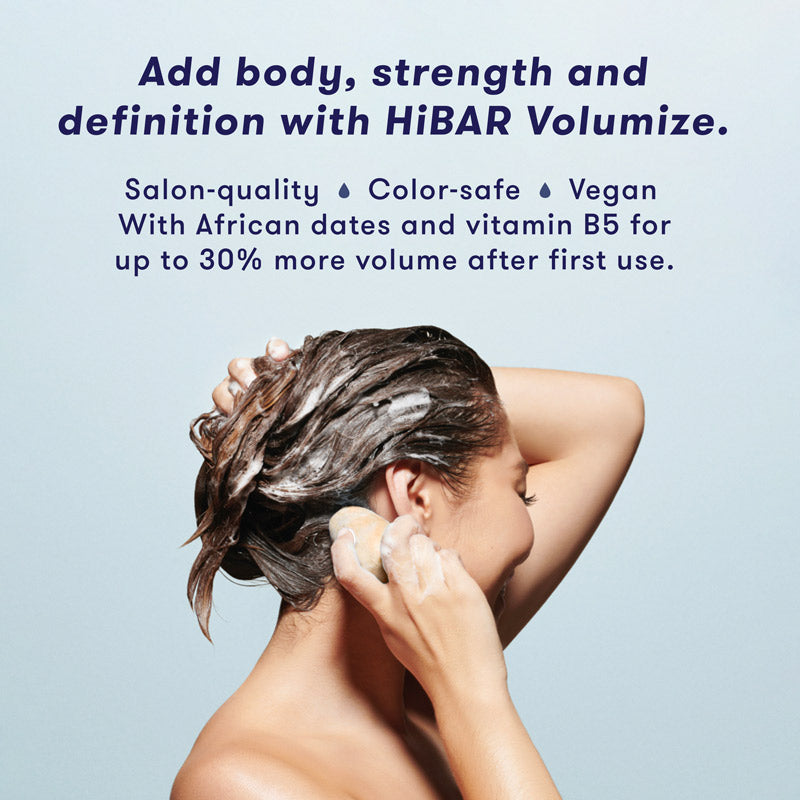 Woman washing hair with shampoo bar. HiBAR Volumize shampoo bar gives your hair body, strength and definition, and is salon-quality, color-safe, vegan, and contain African dates and vitamin B5 for up to 30% more volume after as little as one use. 